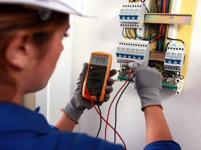 An electrical worker testing a circuit