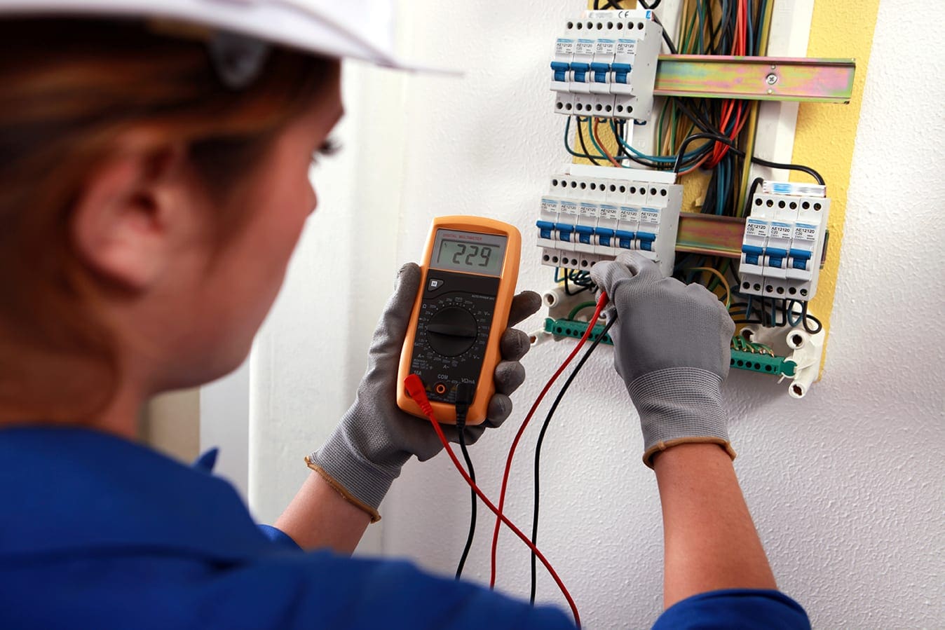 An electrical worker testing a circuit
