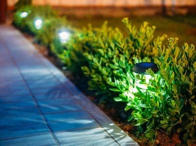 a walkway with exterior garden lighting