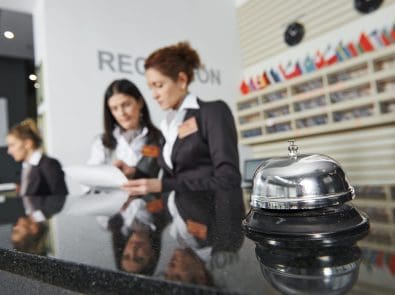 three concierge employees at their desk