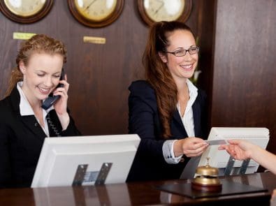 two concierge employees at their desk