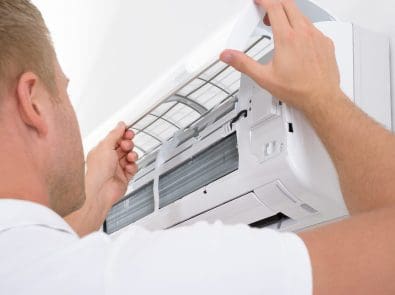 a technician repairing an air conditioner