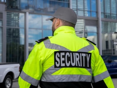 Security guard in uniform patrolling a residential area.