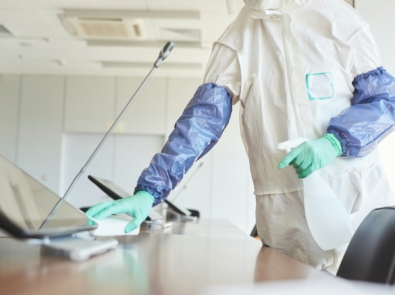 Worker Cleaning Office Table Close Up