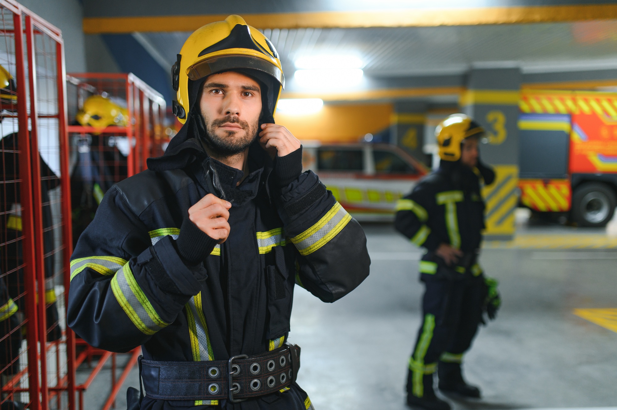 A firefighter puts on a fire uniform at the fire department